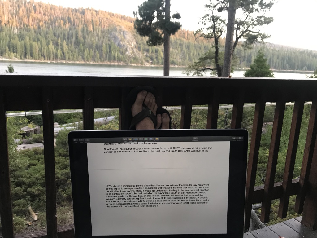 Writing a novel lakeside at sunset