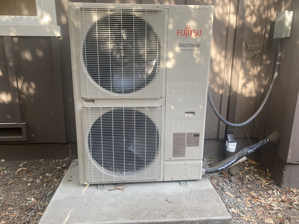 Fujitsu heat pump unit installed outside home