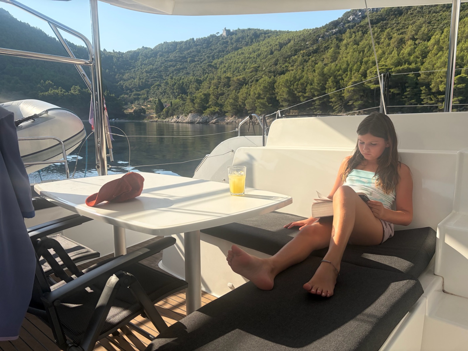 Reading in the cockpit while anchored in a quiet cove